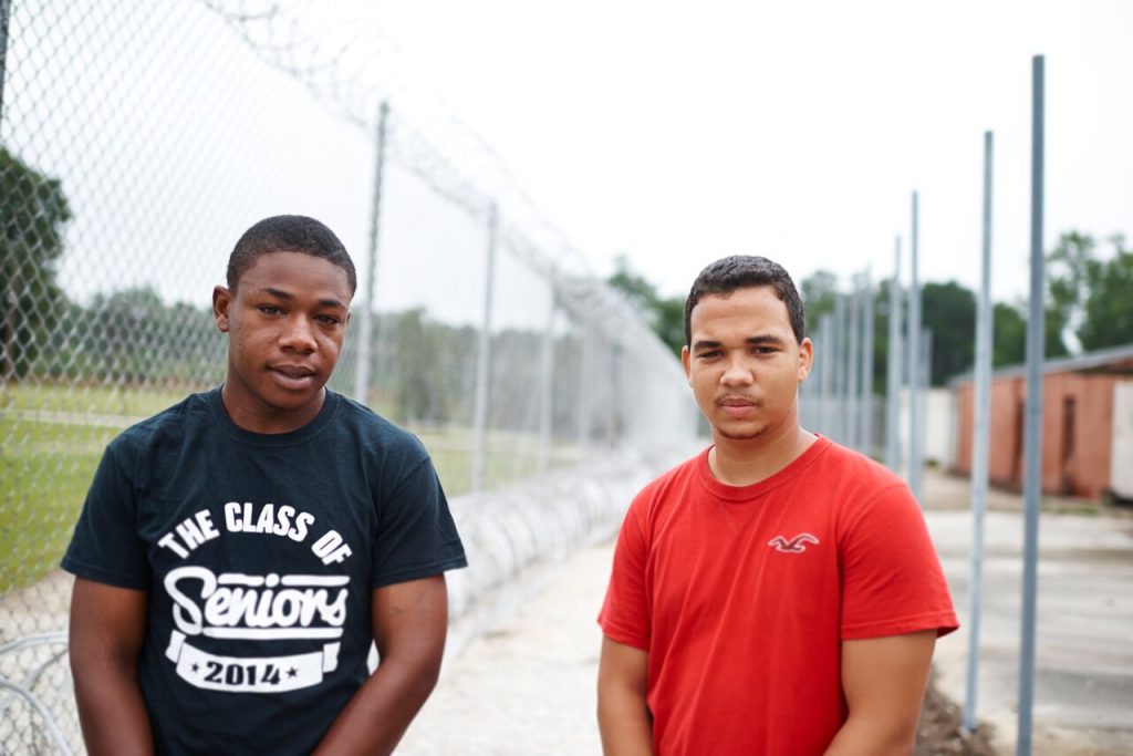 Two youth leaders stand outside a former prison
