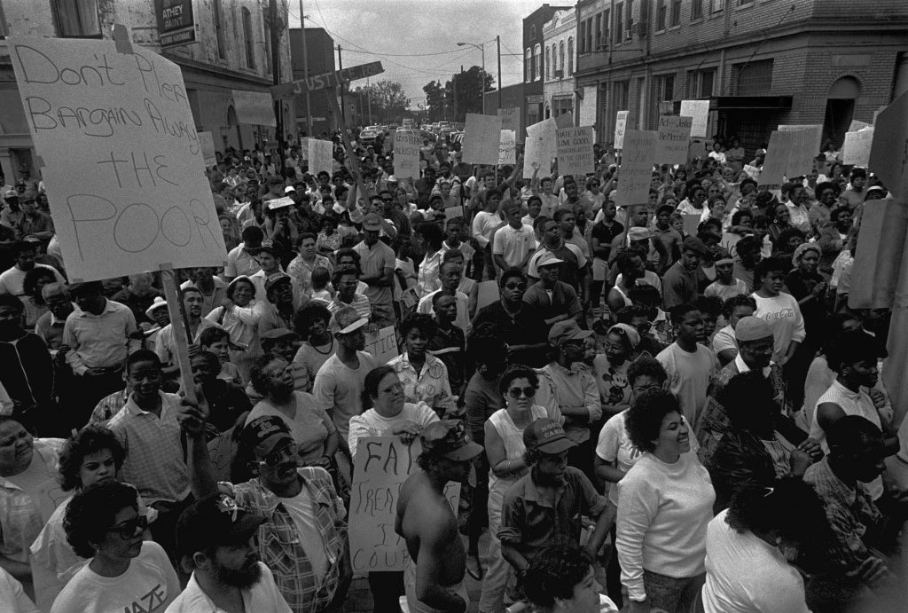Black and white photograph of a large gathering of protester, many with signs